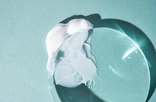 A smear of cream against a background of glass prisms on a blue background. photo