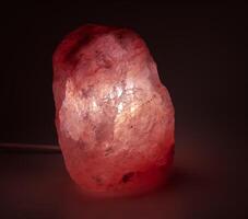 Orange salt lamp. When heated, the air is enriched with useful substances. Healthy lifestyle concept. photo