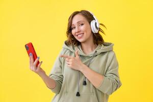 Happy teeth smile woman listen music headphones yellow background photo