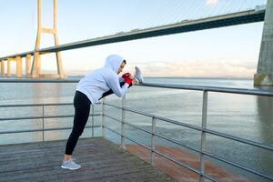 Athlete woman stretching legs outdoor photo