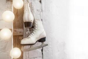 White skates at the wooden staircase. New year interior photo