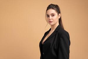 Young business woman close up portrait dressed black jacket standing studio isolated on color background. photo