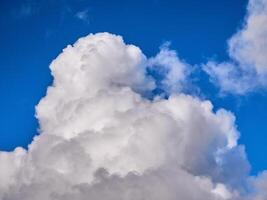 White fluffy clouds in the deep blue sky. Heaven background photo