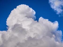 White fluffy clouds in the deep blue sky. Heaven background photo