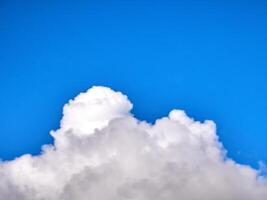 White fluffy clouds in the deep blue sky. Heaven background photo