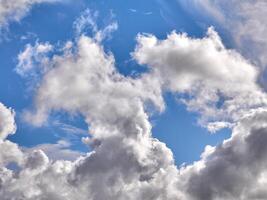 White fluffy clouds in the deep blue sky. Heaven background photo