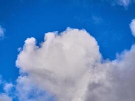 White fluffy clouds in the deep blue sky. Heaven background photo