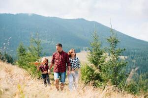 Young family with child resting on a mountain. vacation in the national park photo