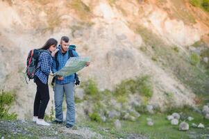 Happy romantic Couple Man and Woman Travelers with backpack holding hands mountaineering Travel Lifestyle and relationship love concept mountains landscape on background photo