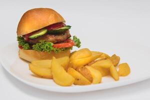 tasty hamburger, French fries and chili sauce on white plate, Fast food with copy space photo