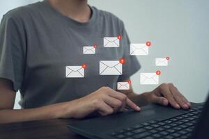 Businesswoman uses keyboard with email message notification. photo