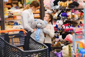 Mother with daughter at a grocery store photo