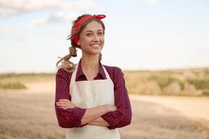 Woman farmer apron standing farmland smiling Female agronomist specialist farming agribusiness Happy positive caucasian worker agricultural field photo