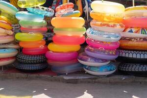 Many inflatable multi colored circles sold on market photo