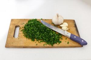 cutting board knife onion garlic photo