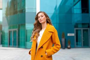 Business woman dressed yellow coat photo