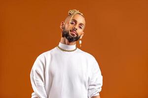 Black latin gay man isolated on orange background photo