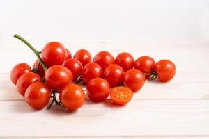 Cherry tomatoes on the white wooden table photo