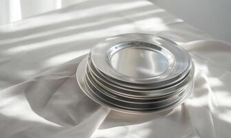 AI generated Set of silver round plates on a white fabric background. Selective focus. photo