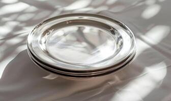 AI generated Set of silver round plates on a white fabric background. Selective focus. photo