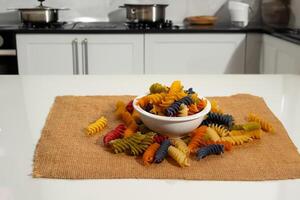 fusilli pasta on kitchen table photo