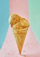 Delicious ice cream cone with nuts isolated on multicolor background photo