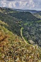 Peaceful Green Hills and Cloudy Blue Sky Landscape with Vibrant Colors photo