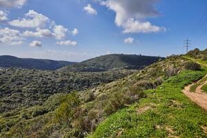 Peaceful Green Hills and Cloudy Blue Sky Landscape with Vibrant Colors photo