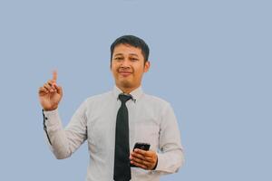 Adult man showing happy expression with finger pointing up when holding mobile phone photo