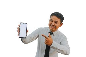 Adult Asian man smiling happy while showing blank mobile phone screen and pointing on it photo