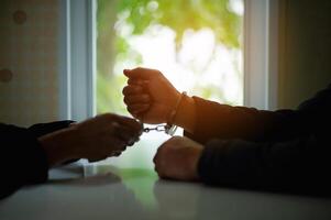 Arresting offenders who are wearing handcuffs, breaking the law, breaking the law, being a suspect and an accused person under a court warrant in the case. photo