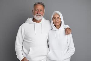AI generated Elderly couple in white hoodie on grey background for clothing mockup photo