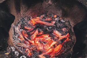 Image of charcoal being burned in an ancient clay oven photo