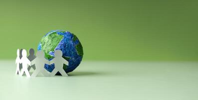 World Earth Day Concept. Green Energy, ESG, Renewable and Sustainable Resources. Environmental Care. Paper Cut as Group of People  Embracing a Green Globe. Protecting Planet Together. Top View photo