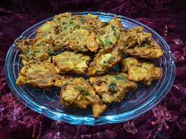 A plate filled with crispy and tasty Pakora - Street Food photo