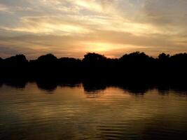 Beautiful Sunset Sky reflecting in the lake or river photo