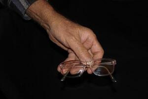 Glasses and senior man's hands photo