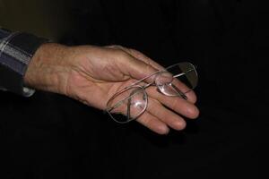 Glasses and senior man's hands photo