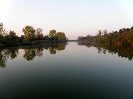 Autumn Colorful Trees Reflecting in Tranquil River photo