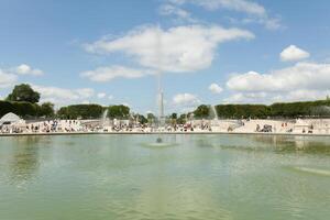 PARIS, FRANCE - 02 June 2018 Local and Tourist enjoy first sunny days in famous Tuileries garden. Jardin des Tuileries is a public garden located between Louvre Museum and Place de la Concorde. photo