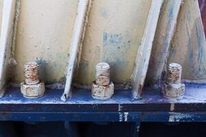 Big rusty metal nuts locked with rust and corrosion bolts photo