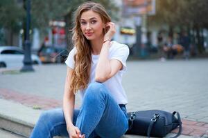 Woman city street summer sitting stairs outdoor park Modern stylish travel girl with backpack resting happy smiling on city street photo