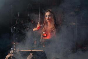 Halloween, witch use magic book and cauldron prepare poison or love potion photo