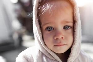 a baby wearing a hooded robe photo