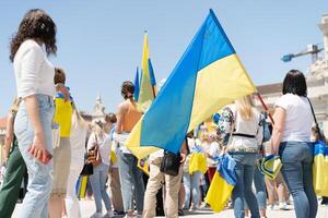 Portugal, Lisbon April 2022 The demonstration on Commerce Square in support of Ukraine and against the Russian aggression. Protesters against Russia's war Many people with Ukrainian flags. photo