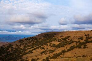 windmills on the mountain near the sea harbor photo