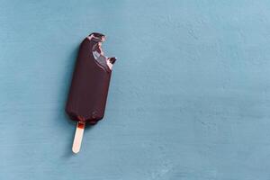 ice cream stick  on dark  background  covered chocolate sticks frozen Popsicle and Lolly sweet dessert  Flat lay photo
