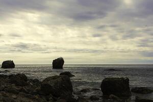 big stone in the sea photo