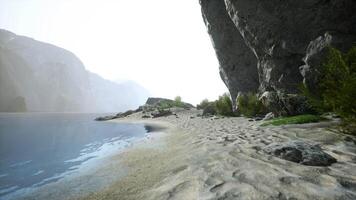 un' soleggiato spiaggia con un' sbalorditivo scogliera fondale video