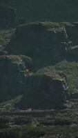 A group of large rocks in the middle of a field video